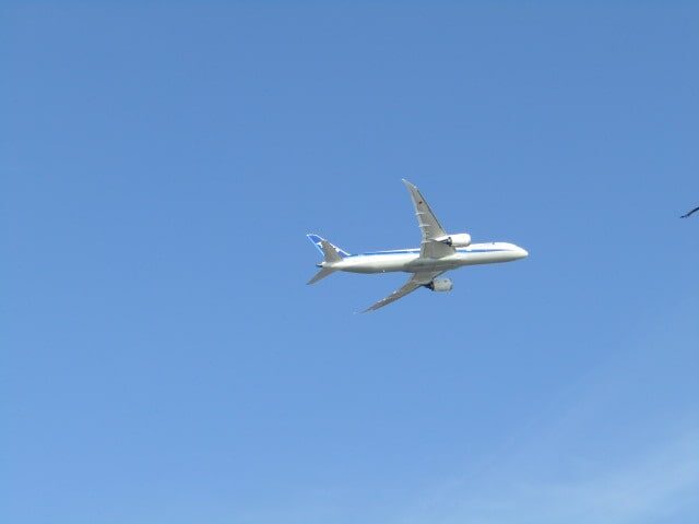 羽田空港を離陸して多摩川上空を飛んでいく飛行機。